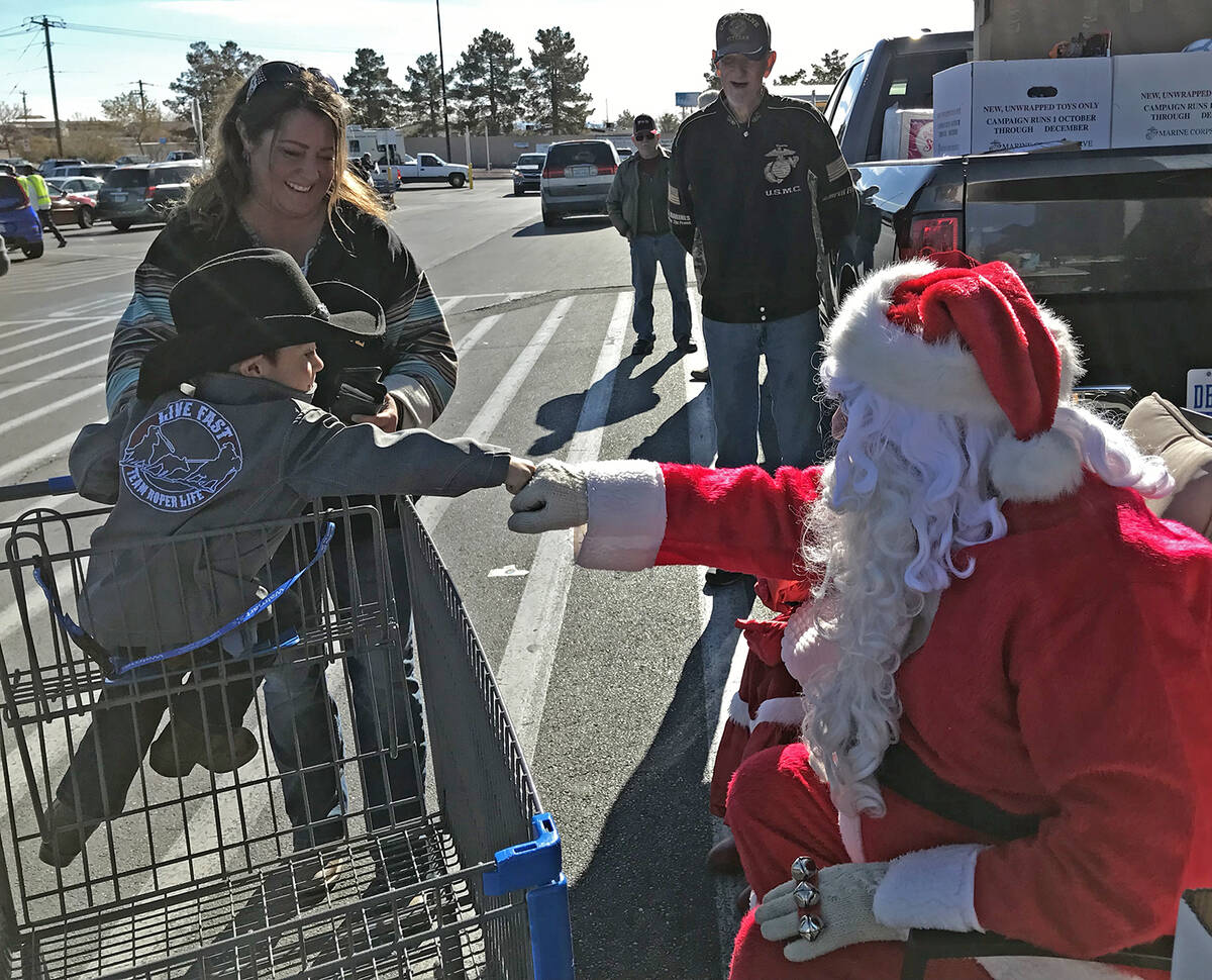 Robin Hebrock/Pahrump Valley Times Santa shares a friendly fist bump with a local youngster.