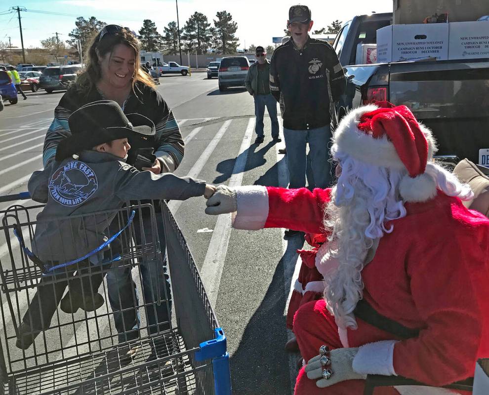 Robin Hebrock/Pahrump Valley Times Santa shares a friendly fist bump with a local youngster.