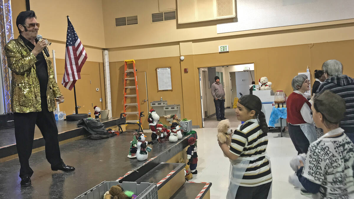 Robin Hebrock/Pahrump Valley Times Local Elvis impersonator Johnny V is shown handing out teddy ...