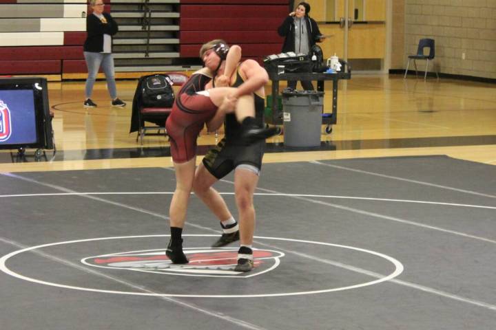 Danny Smyth/Pahrump Valley Times Senior wrestler Tannor Hanks lifting up his opponent to slam h ...