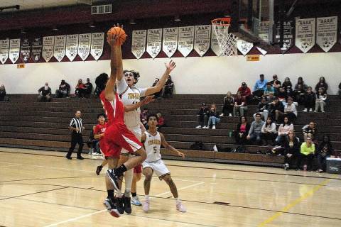 Horace Langford Jr./Pahrump Valley Times Forward Ryder Cordova (11) going up for a block agains ...