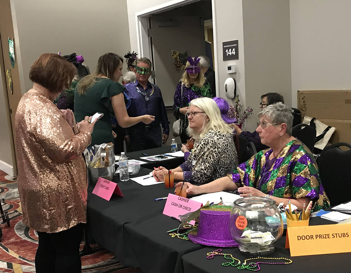 Robin Hebrock/Pahrump Valley Times Mardi Gras attendees are pictured checking in for the event.