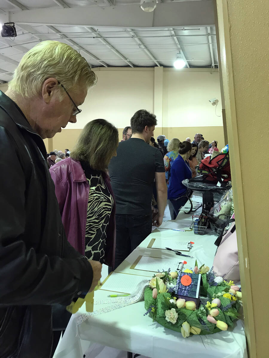 Robin Hebrock/Pahrump Valley Times Crab Fest attendees are seen browsing the silent auction items.