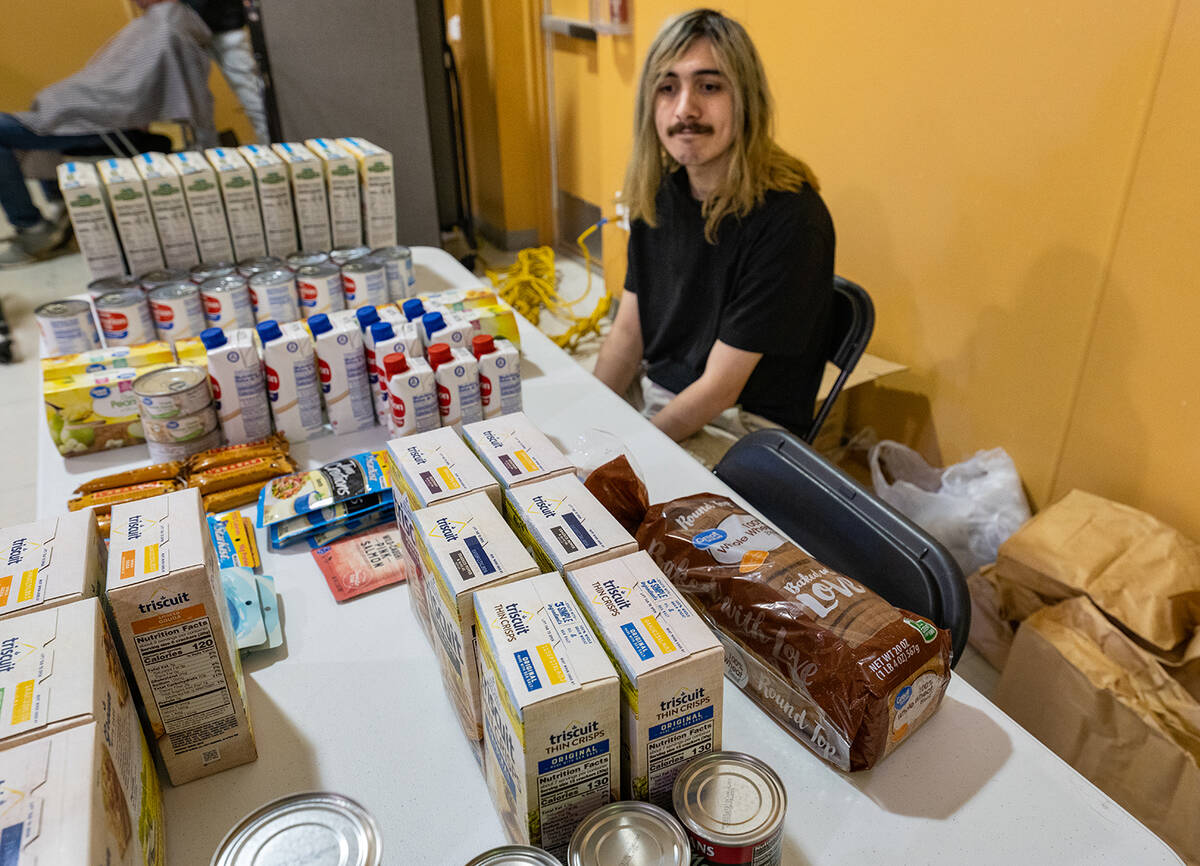 John Clausen/Pahrump Valley Times A NyECC Youth WERKS member handed out free nonperishable food ...