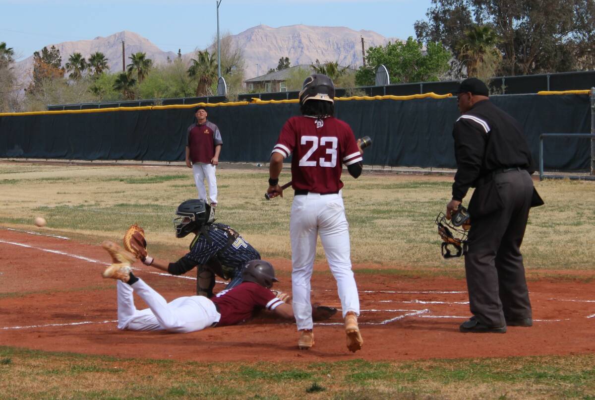 Danny Smyth/Pahrump Valley Times James Metscher (4) dives into home plate to score as teammate ...