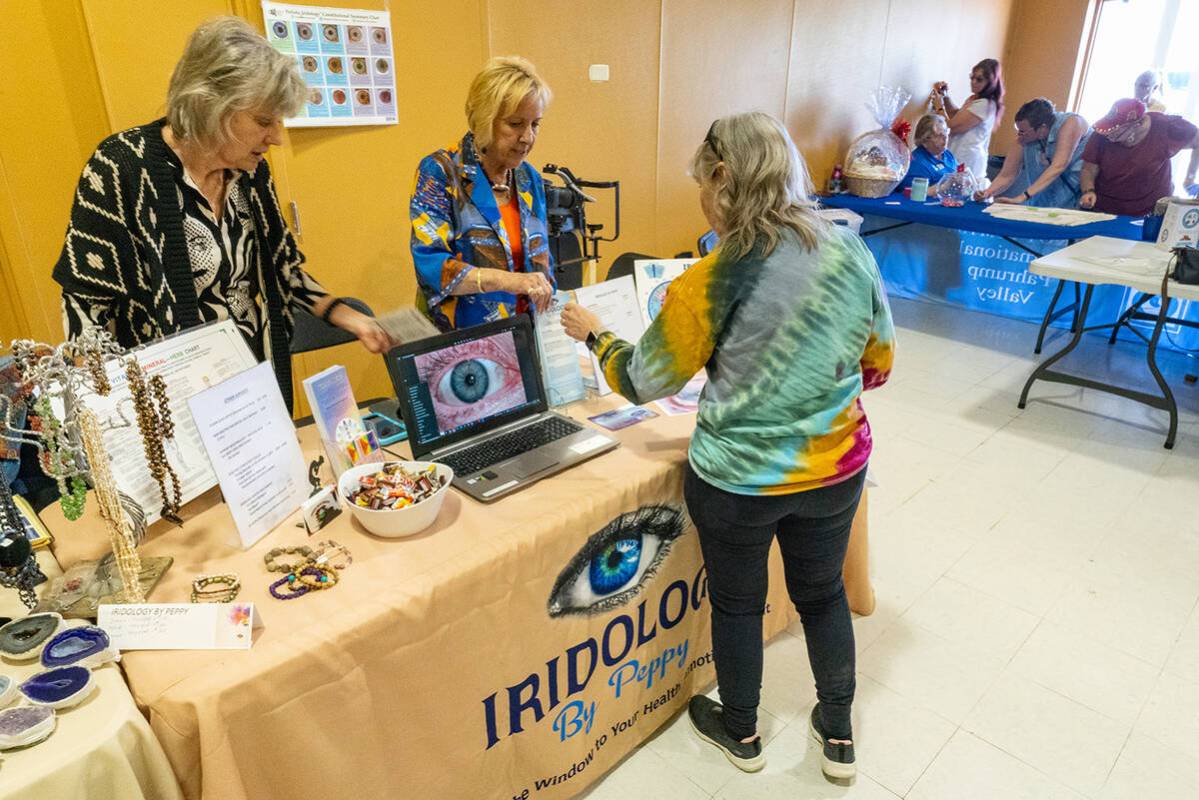 John Clausen/Pahrump Valley Times A Women's Fair attendee is pictured speaking with a represent ...