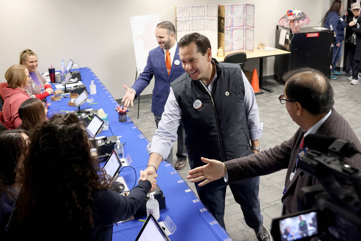Nevada Secretary of State Cisco Aguilar, second from right, is introduced to poll workers by He ...