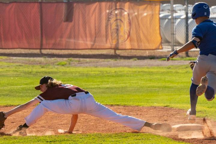 John Clausen/Pahrump Valley Times Matt Array (9) stretching out for the ball to secure an out i ...