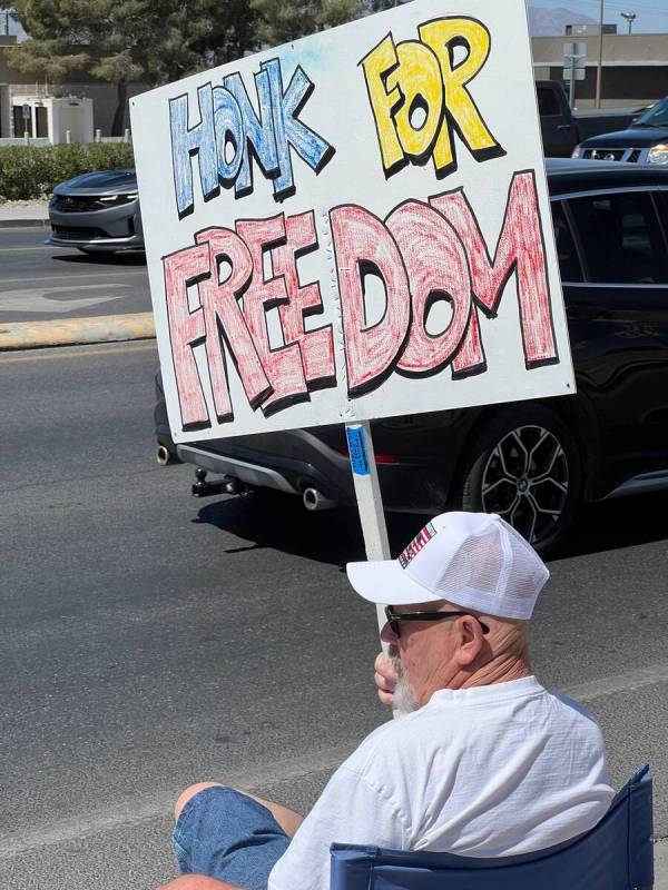 Bill Newyear/Special to the Pahrump Valley Times A Trump supporter sits in the sun at the corne ...