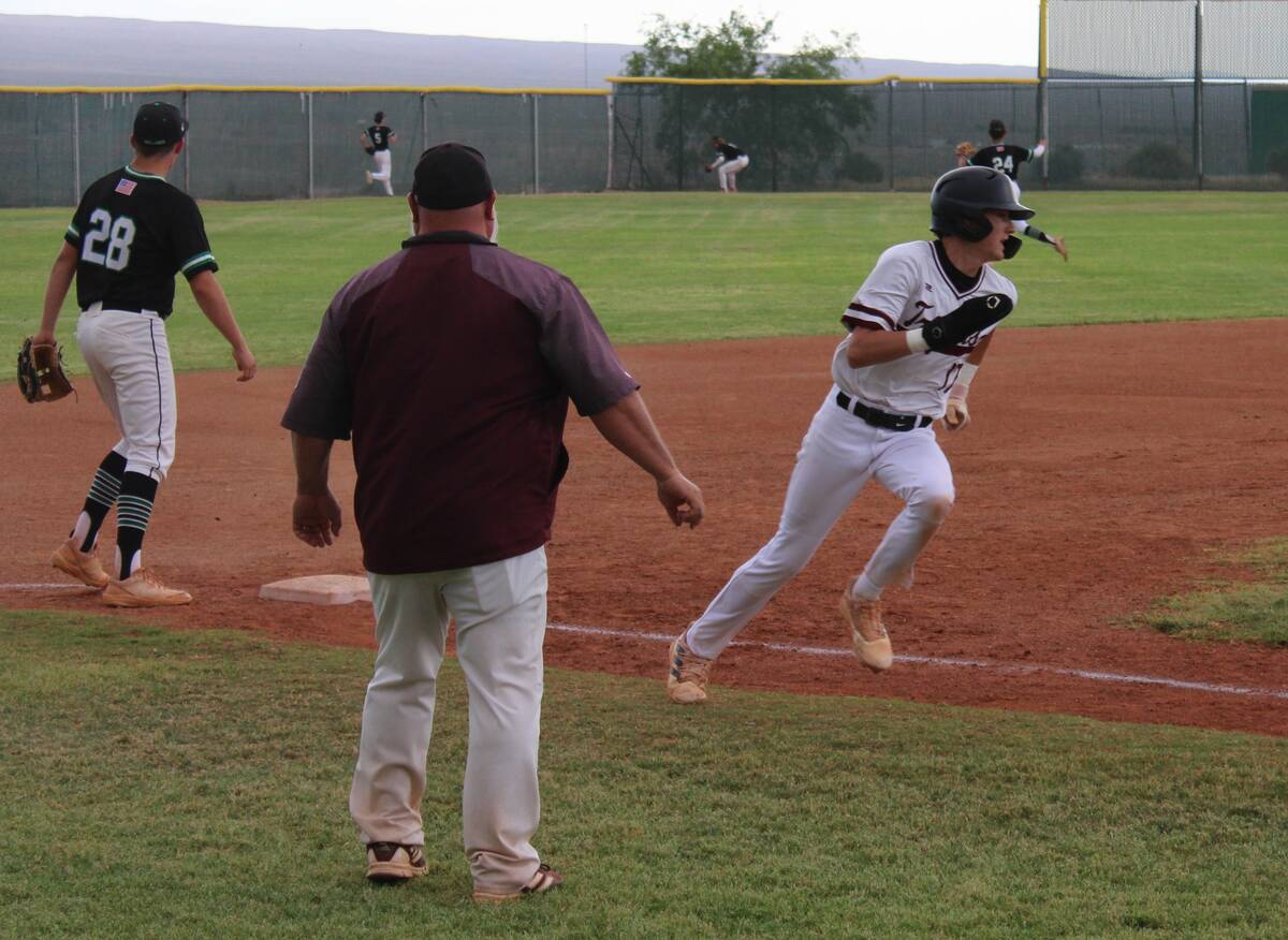 Danny Smyth/Pahrump Valley Times Sophomore Aidyn Cratty (17) being waved home by assistant coac ...
