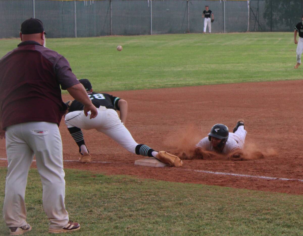 Danny Smyth/Pahrump Valley Times Junior Justin Ybarra (3) diving into third base for a triple d ...