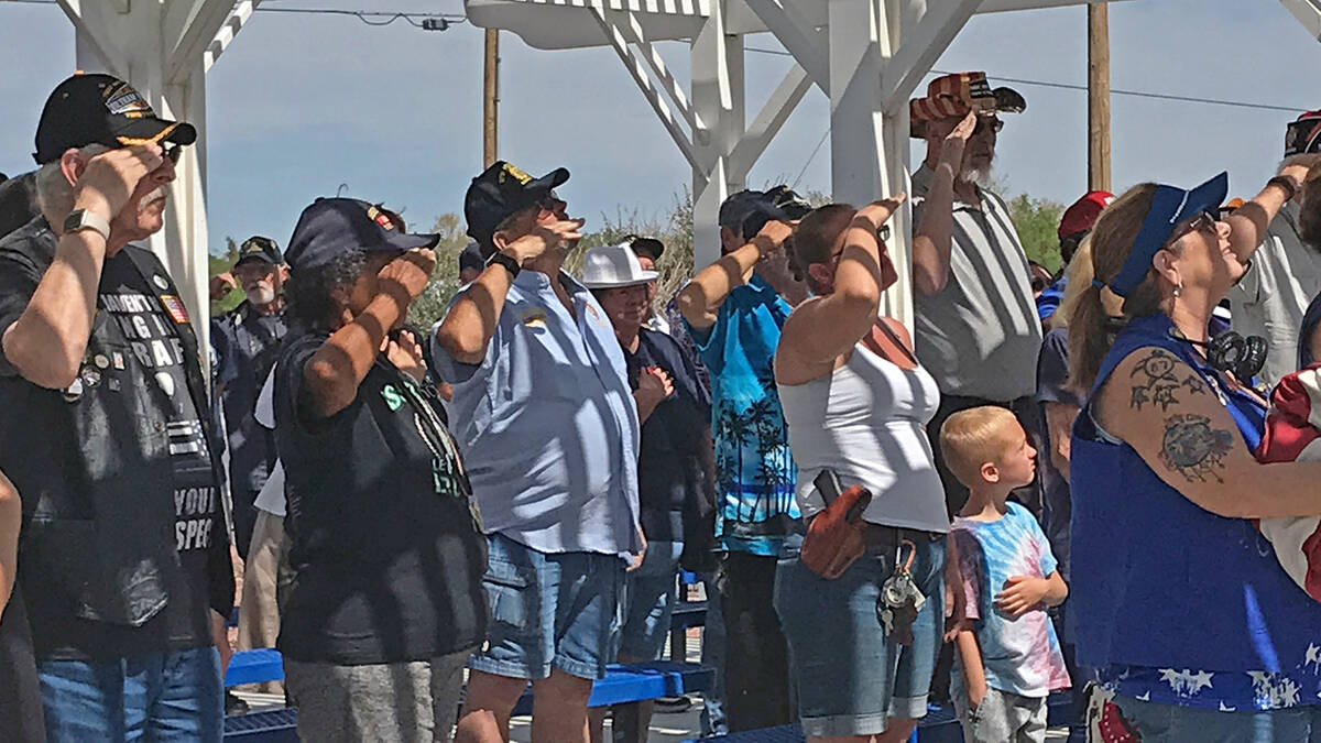 Robin Hebrock/Pahrump Valley Times Memorial Day ceremony attendees are shown saluting the flag ...