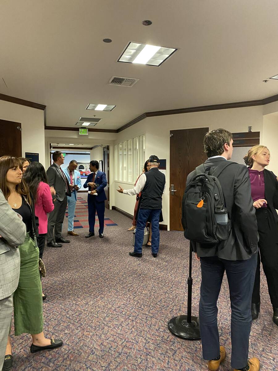 Lawmakers and lobbyists gather outside of a committee room in the Nevada Legislature building o ...