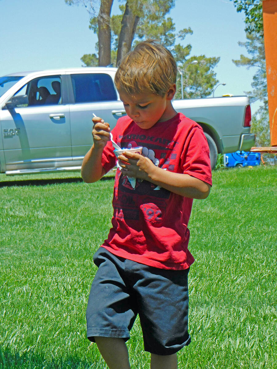 Robin Hebrock/Pahrump Valley Times A youngster digs into his snow cone.