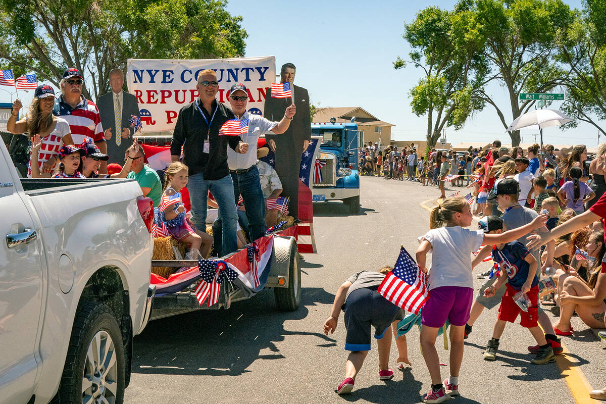 John Clausen/Pahrump Valley Times Area youth are seen picking up candy and other items tossed f ...