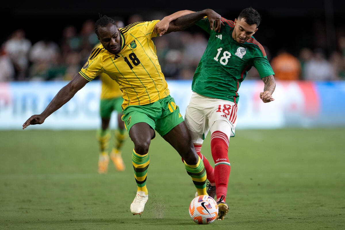 Jamaica forward Michail Antonio (18) and Mexico midfielder Luis Chávez (18) battle for the ...