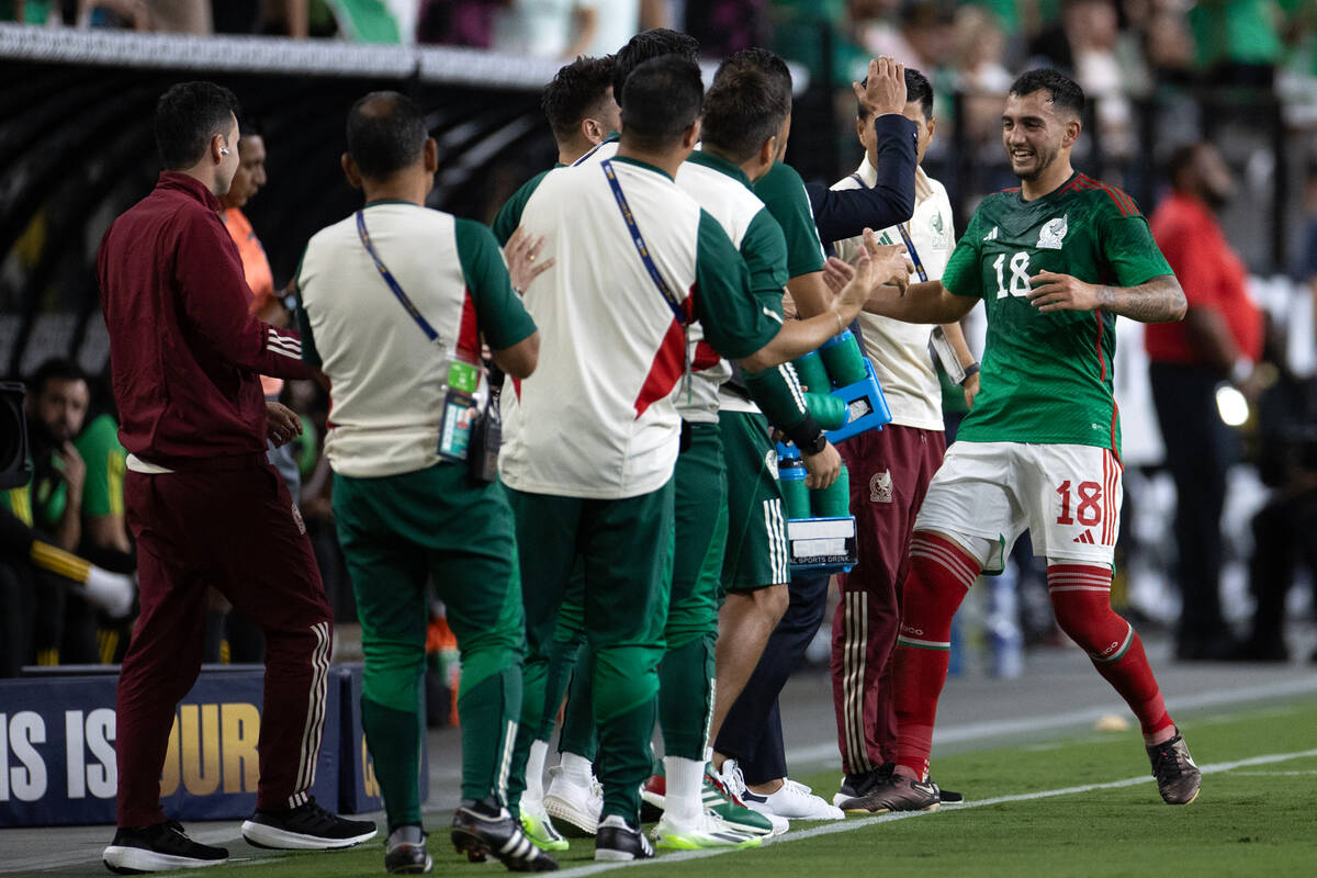 Mexico midfielder Luis Chávez (18) is congratulated by his team after scoring during the f ...