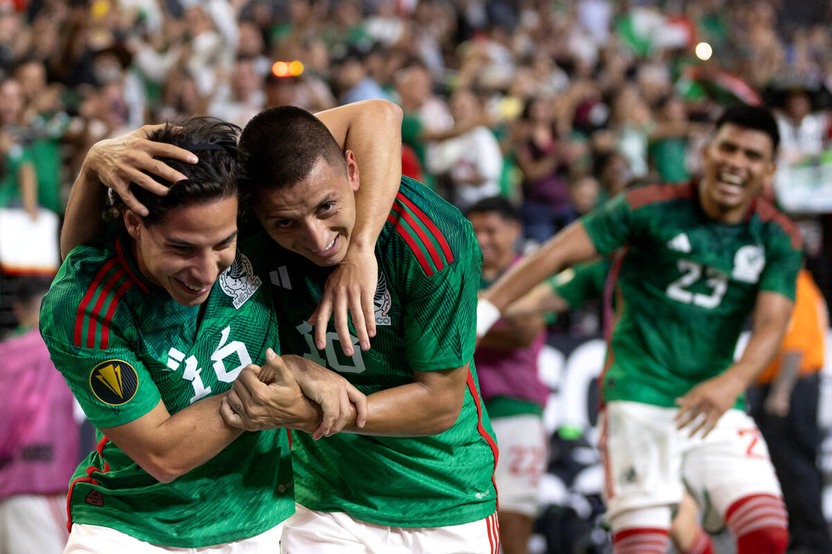 Mexico midfielder Sebastián Córdova (16) and forward Roberto Alvarado (10) embrace af ...