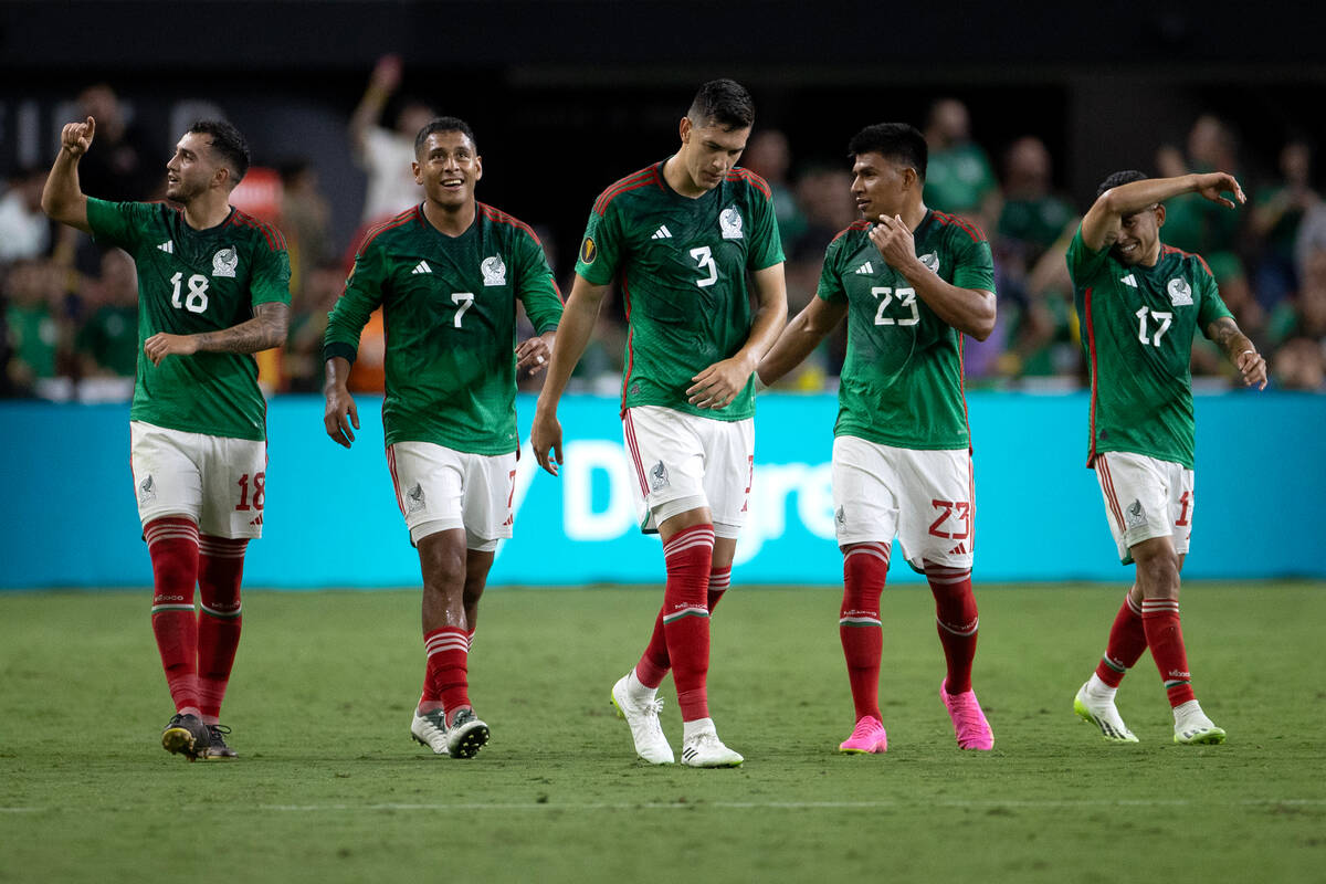 Mexico players head to center field after their team scored during the first half of a CONCACAF ...