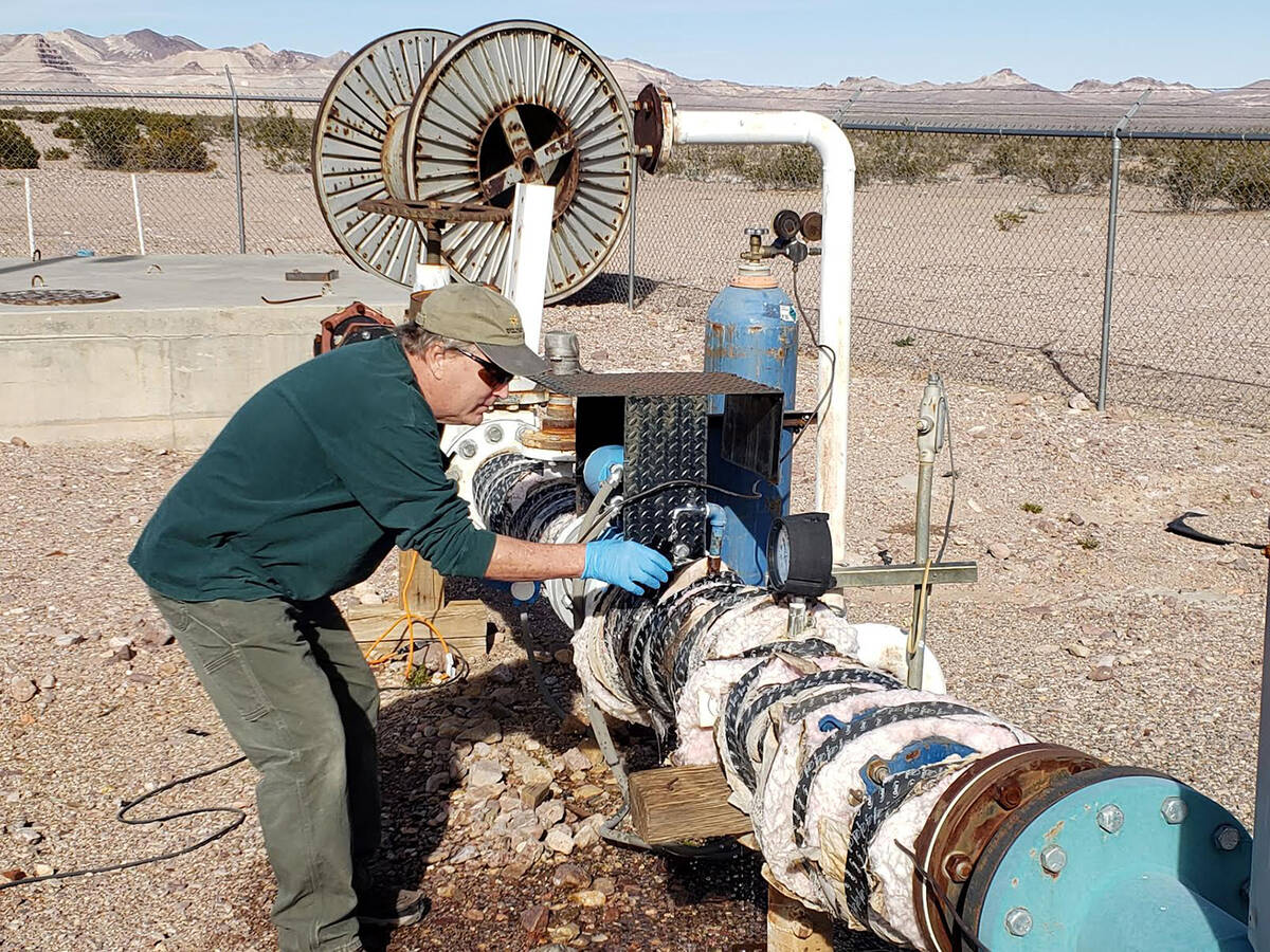 Special to the Pahrump Valley Times Nye County Geoscientist John Klenke is shown taking a sampl ...