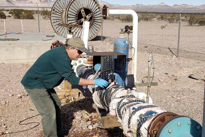 Special to the Pahrump Valley Times Nye County Geoscientist John Klenke is shown taking a sampl ...