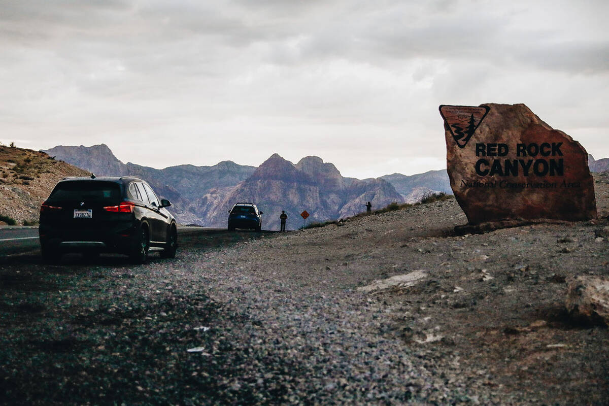 People watch the rain come in near Red Rock Canyon National Conservation Area on Friday, Aug. 1 ...