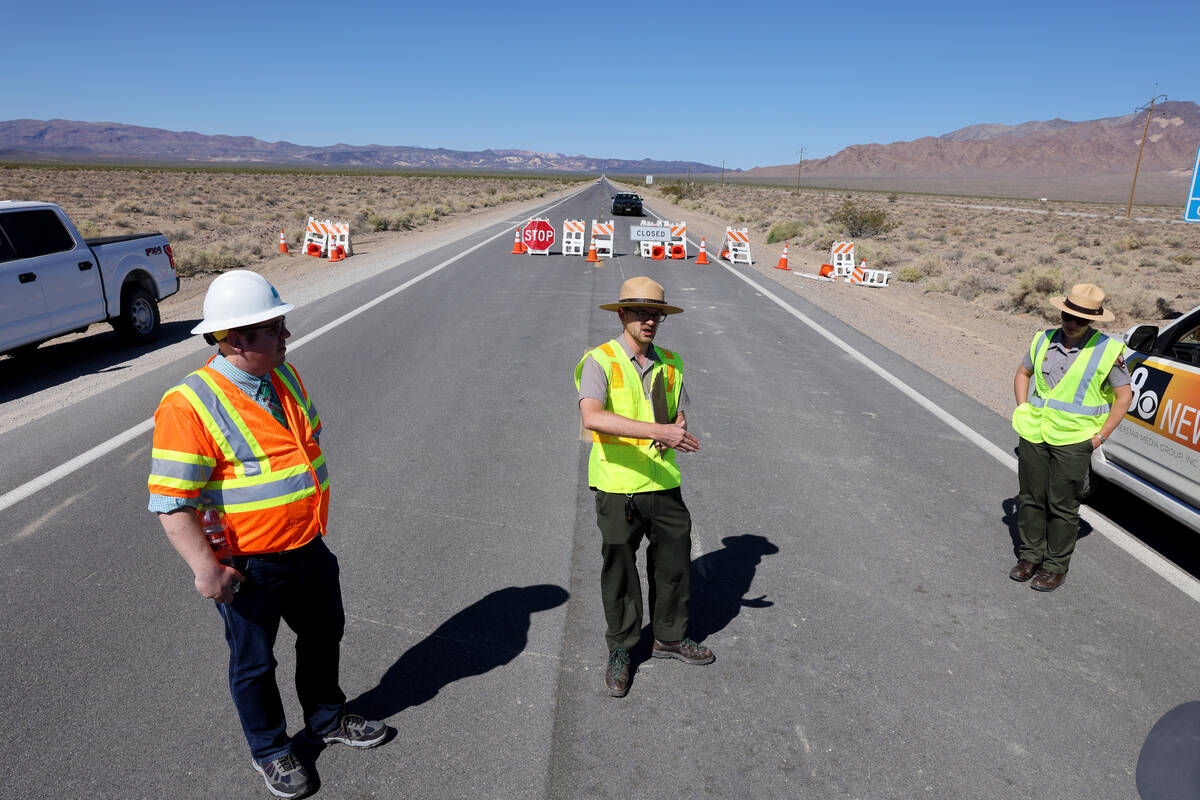 Death Valley park ranger Matthew Lamar, center, talks to the news media during a tour of Hilary ...