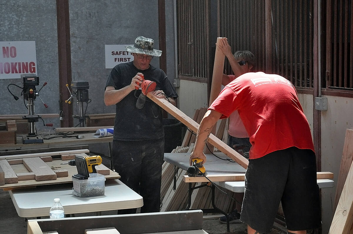 Horace Langford Jr./Pahrump Valley Times filed Volunteers are pictured sanding lengths of board ...