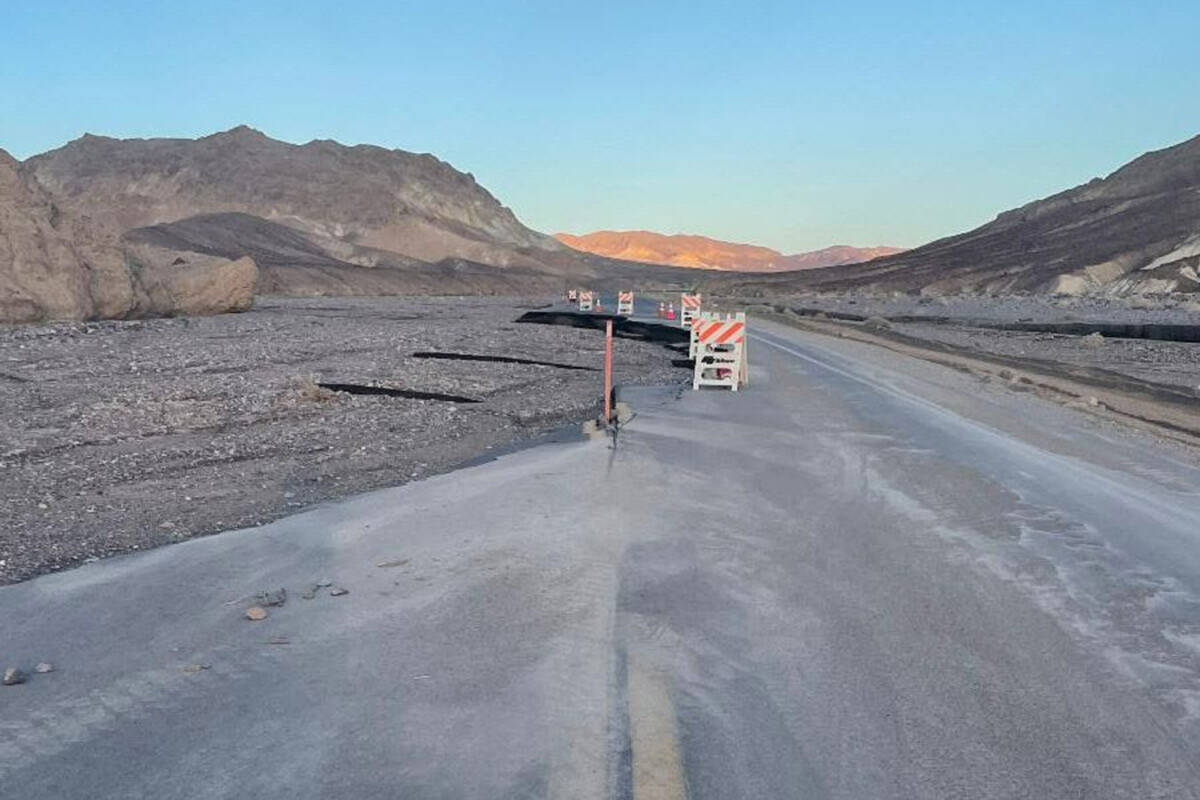 A damaged section of state Route 190 east of Furnace Creek at Death Valley National Park in Cal ...