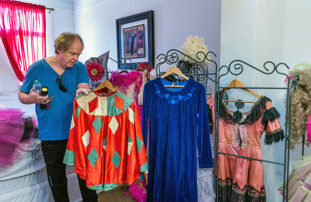 Fred Conboy looks at one of the handmade costumes from former owner and performer Marta Becket ...