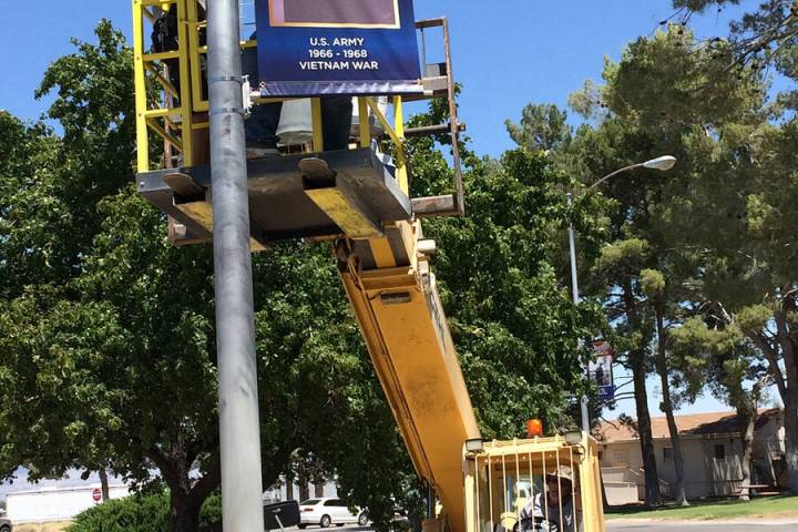 Robin Hebrock/Pahrump Valley Times Nye County Buildings and Grounds crews are pictured hanging ...