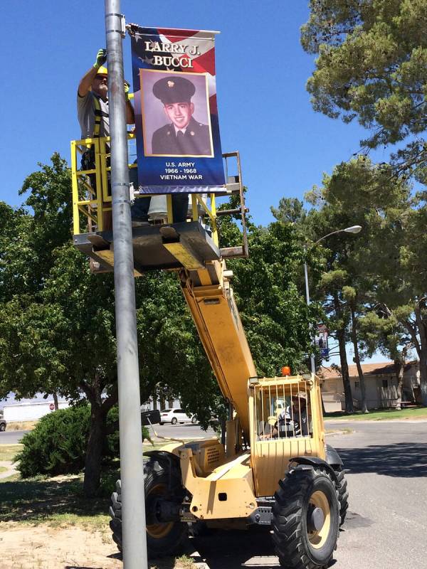 Robin Hebrock/Pahrump Valley Times Nye County Buildings and Grounds crews are pictured hanging ...