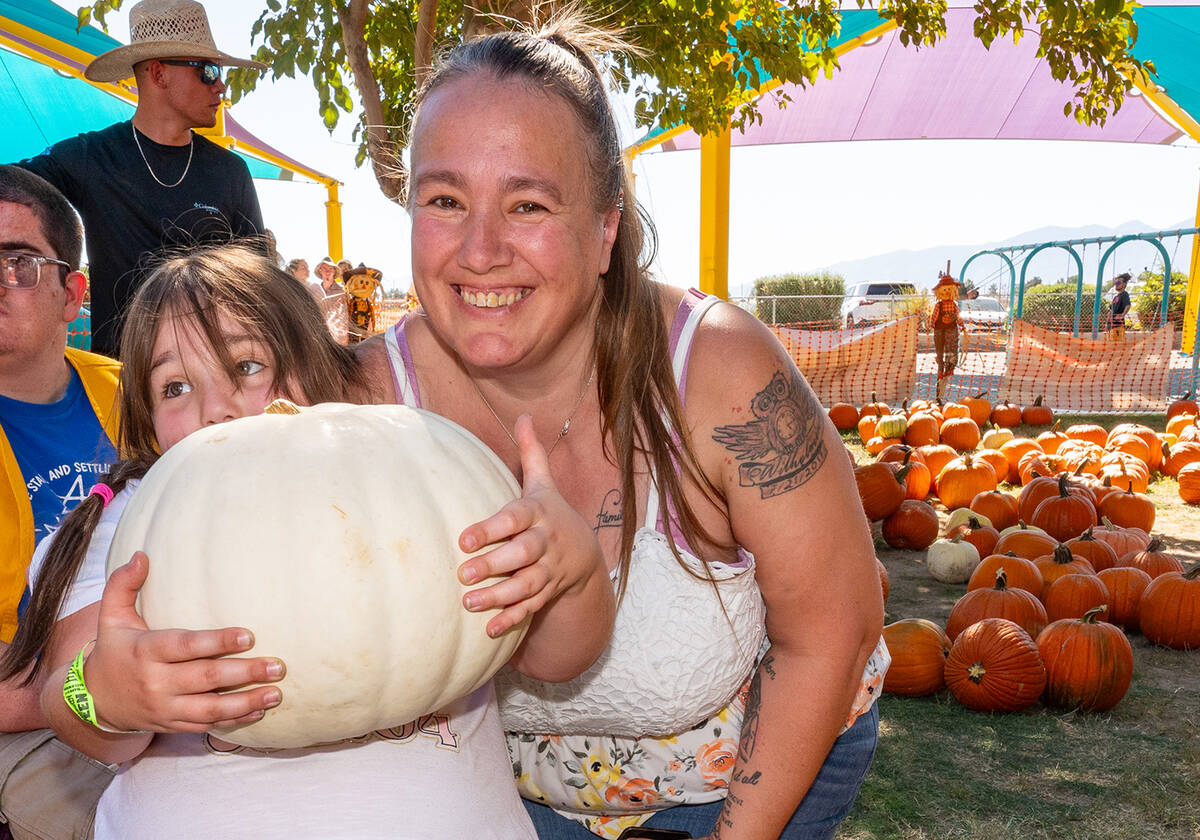 John Clausen/Pahrump Valley Times An area youngster proudly displays the white pumpkin she pick ...