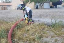 Pahrump Valley Times file A Pahrump Valley firefighter works on a fire hydrant along Bourbon St ...