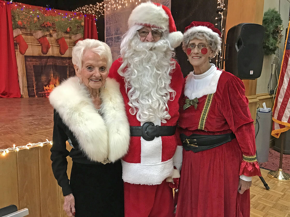 Robin Hebrock/Pahrump Valley Times Silver Tappers founder B.J. Hetrick-Irwin poses with Santa a ...