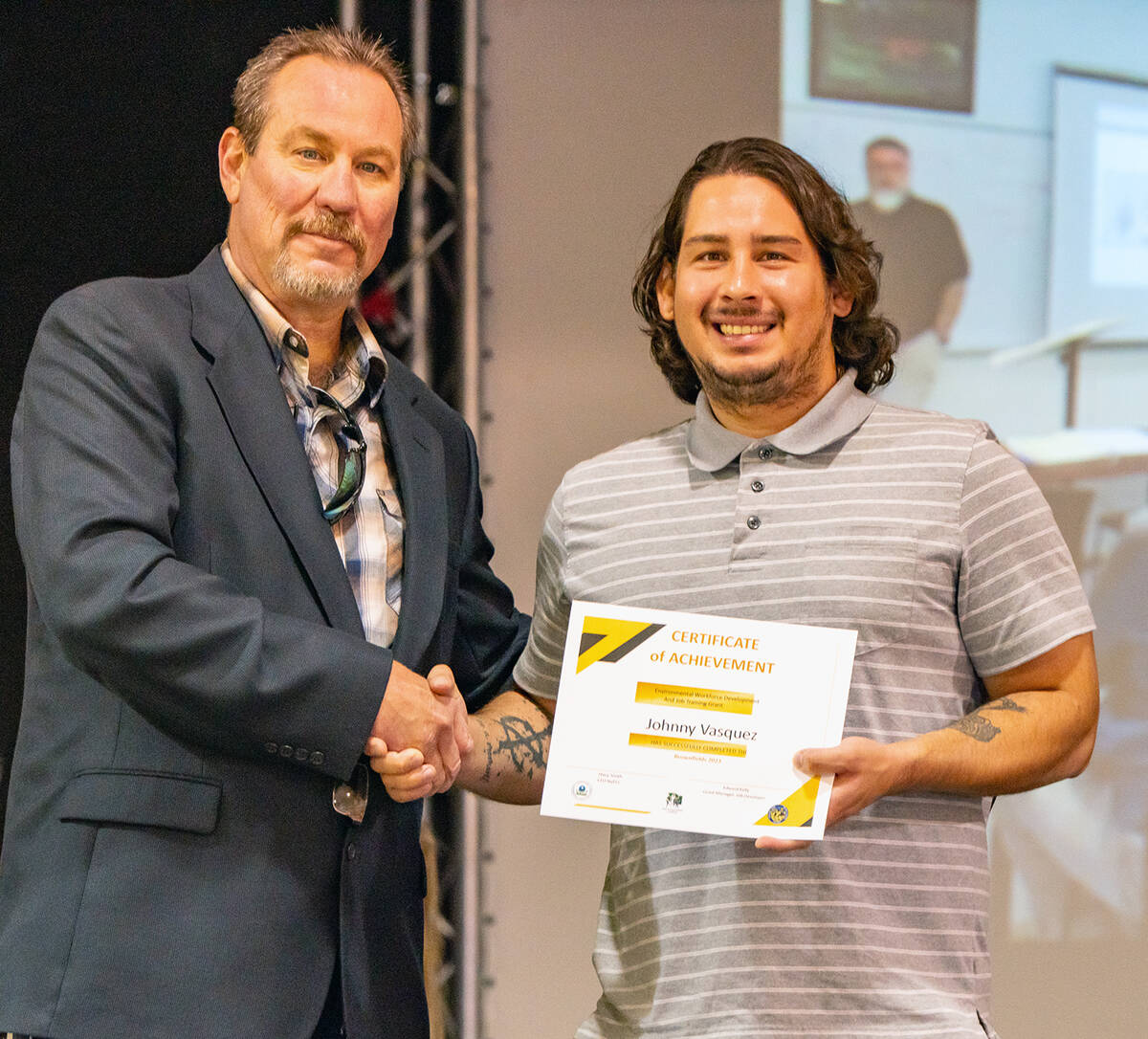 Brownfields Job Training Graduate Johnny Vasquez receives his Certificate of Achievement from N ...