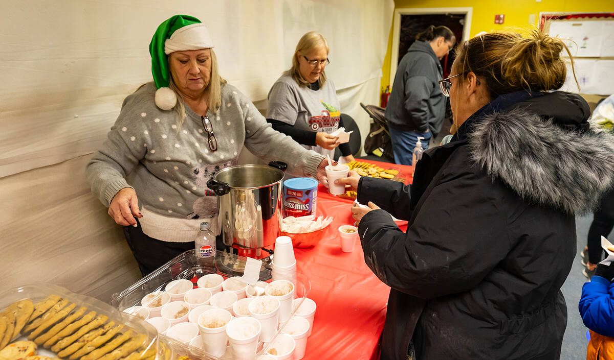 John Clausen/Pahrump Valley Times PDOP members are pictured handing out cookies and cocoa to Co ...