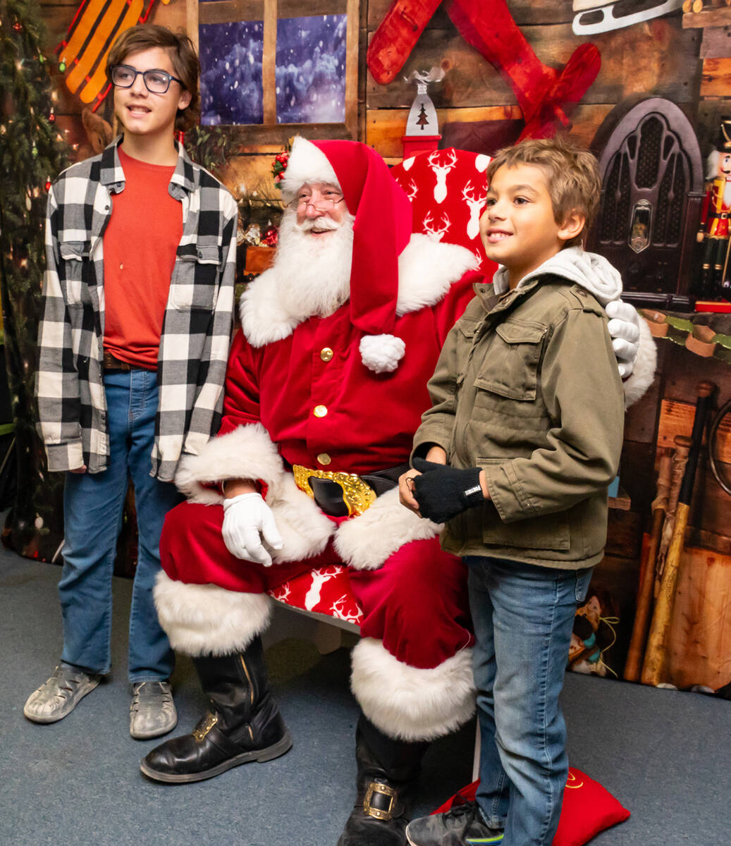 John Clausen/Pahrump Valley Times Two local youth pose for a photo with Santa Claus at PDOP's C ...