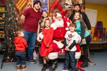 John Clausen/Pahrump Valley Times A local family surrounds Santa Claus for a festive family photo.