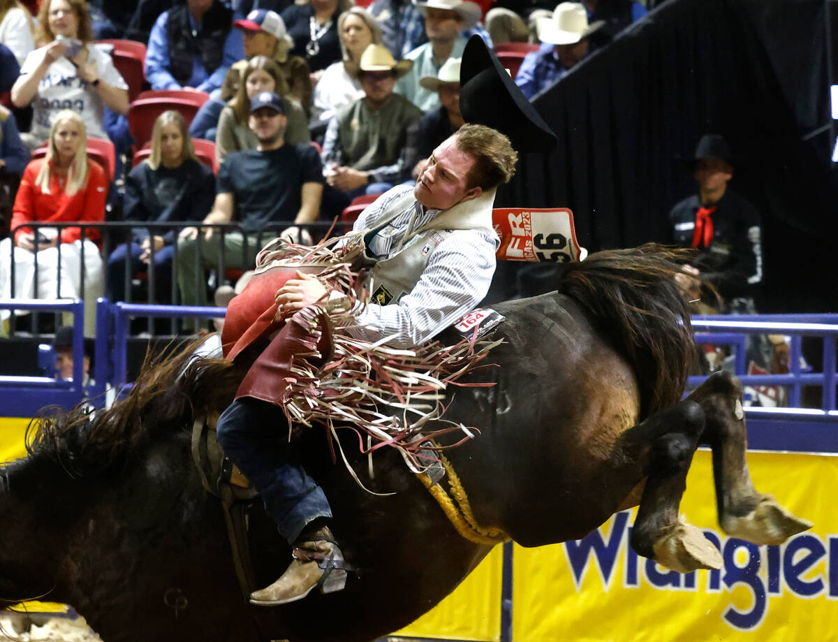 Dean Thompson holds on to his horse while he competes in bareback riding on day six of the Nati ...