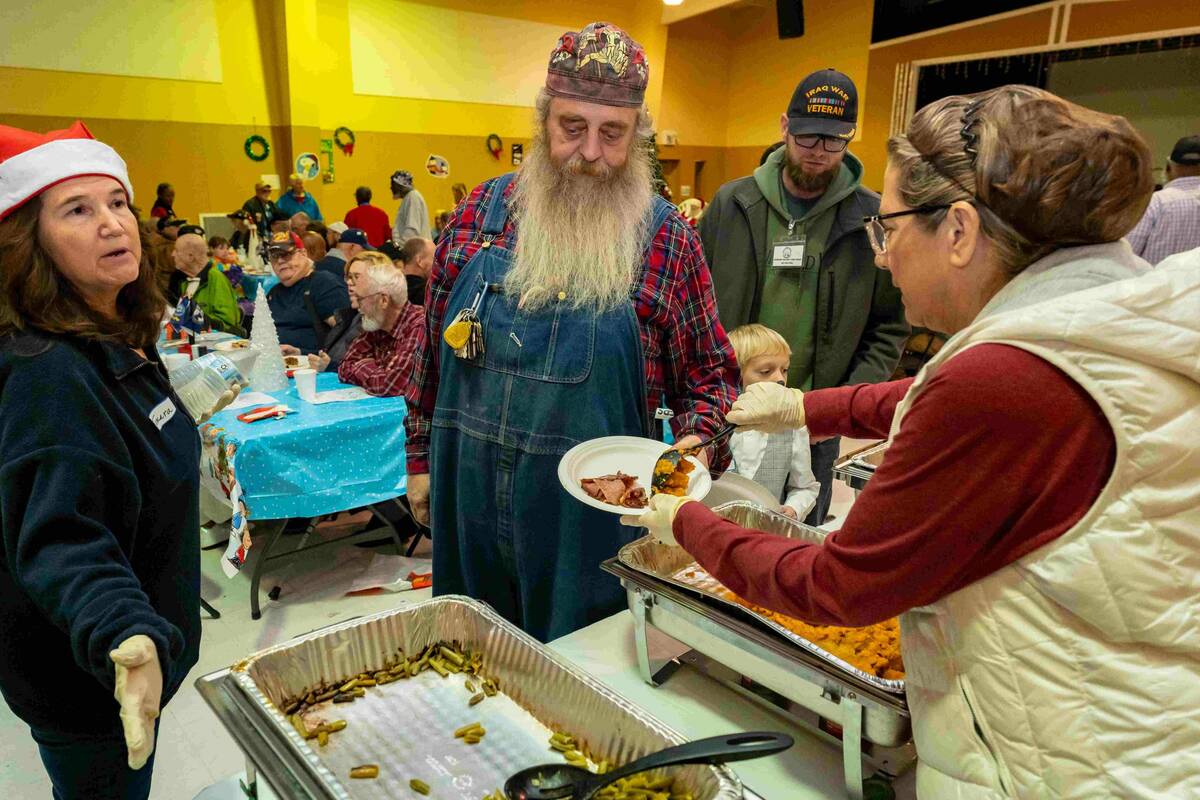 John Clausen/Pahrump Valley Times Guests line up at the free annual Christmas dinner organized ...