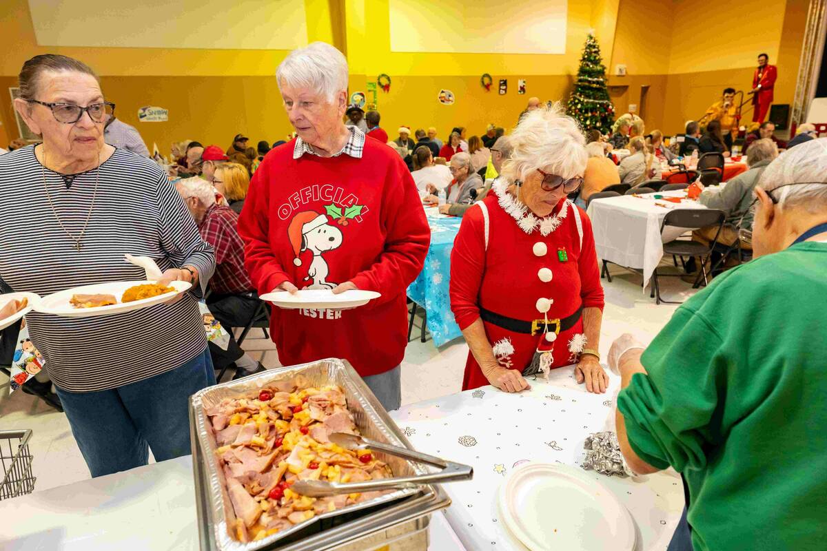 John Clausen/Pahrump Valley Times Ham is served to hundreds attend the Pahrump Holiday Task For ...
