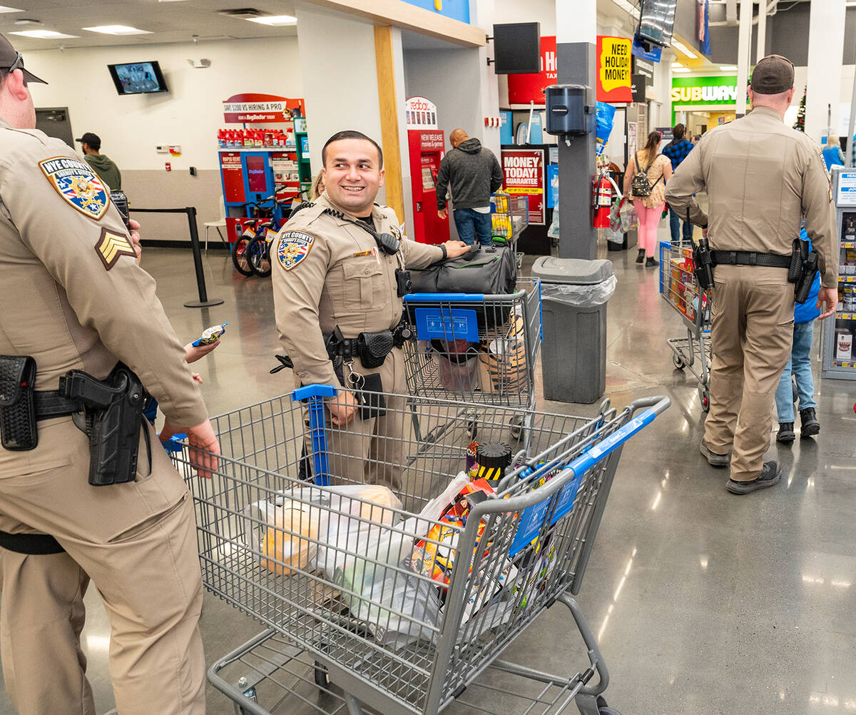 John Clausen/Pahrump Valley Times Local NCSO officers are shown checking out baskets of toys an ...
