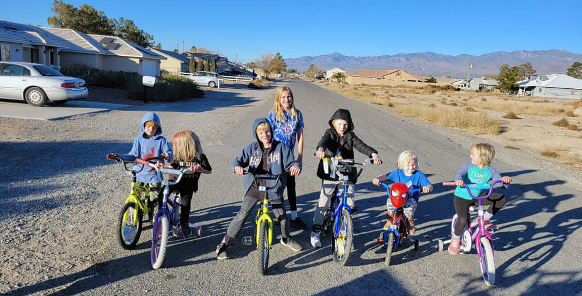 Special to the Pahrump Valley Times Lined up on the street and ready to ride, local kids pause ...