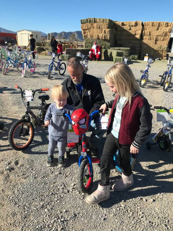 Robin Hebrock/Pahrump Valley Times Scott Sampson, center, is shown helping two youngsters pick ...