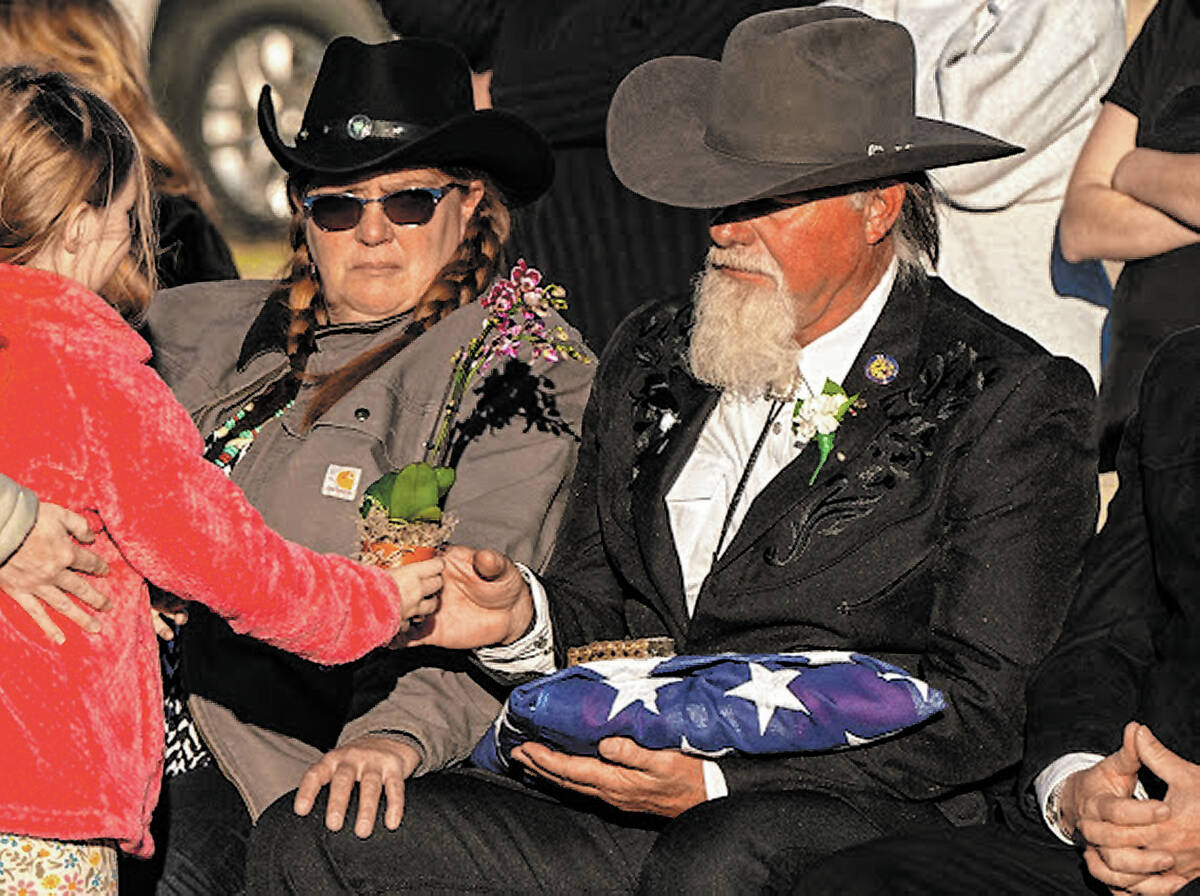 John Clausen/Pahrump Valley Times Survivors of Sharon Wehrly mourn over a U.S. flag ...