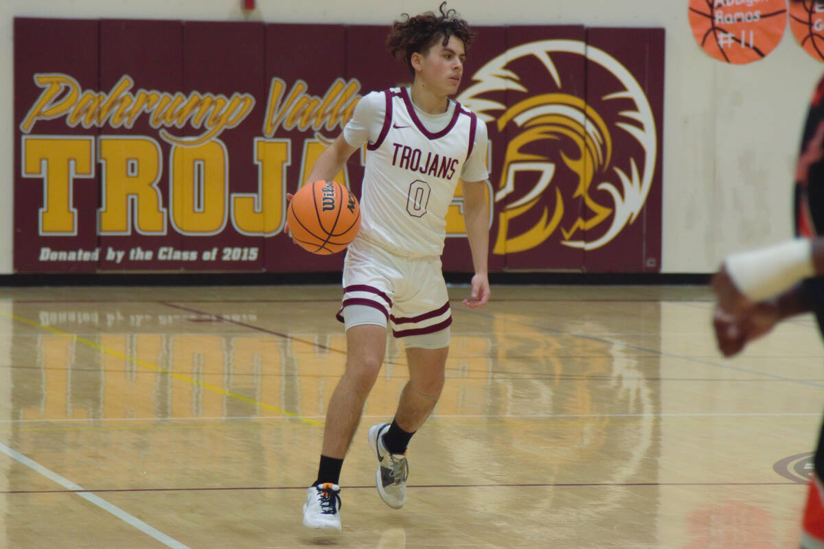 Alejandro Lozano (0) with the Pahrump Valley Trojans dribbling towards the Chaparral Cowboys in ...