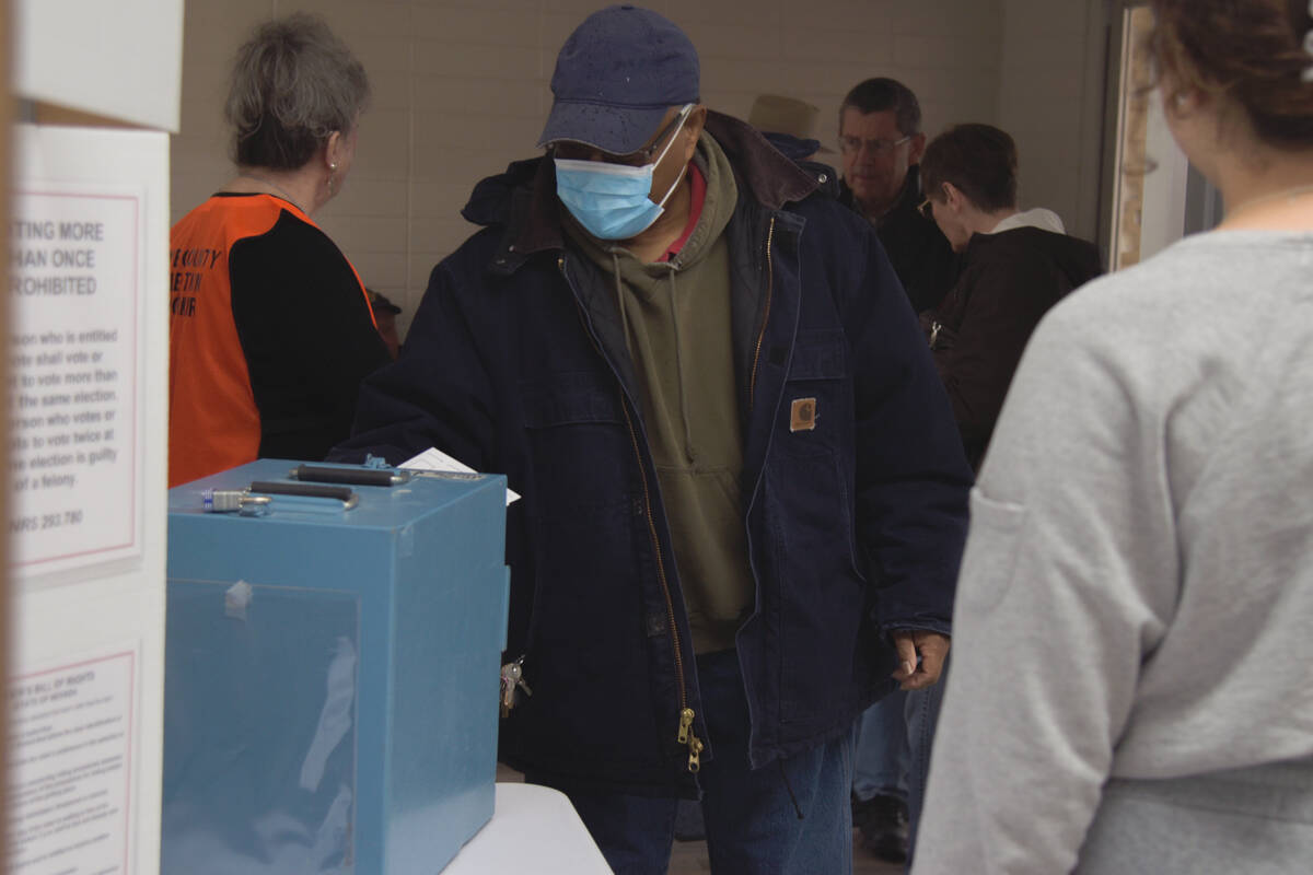 A man cast his ballot inside the Bob Ruud community center for the primary election on Tuesday, ...