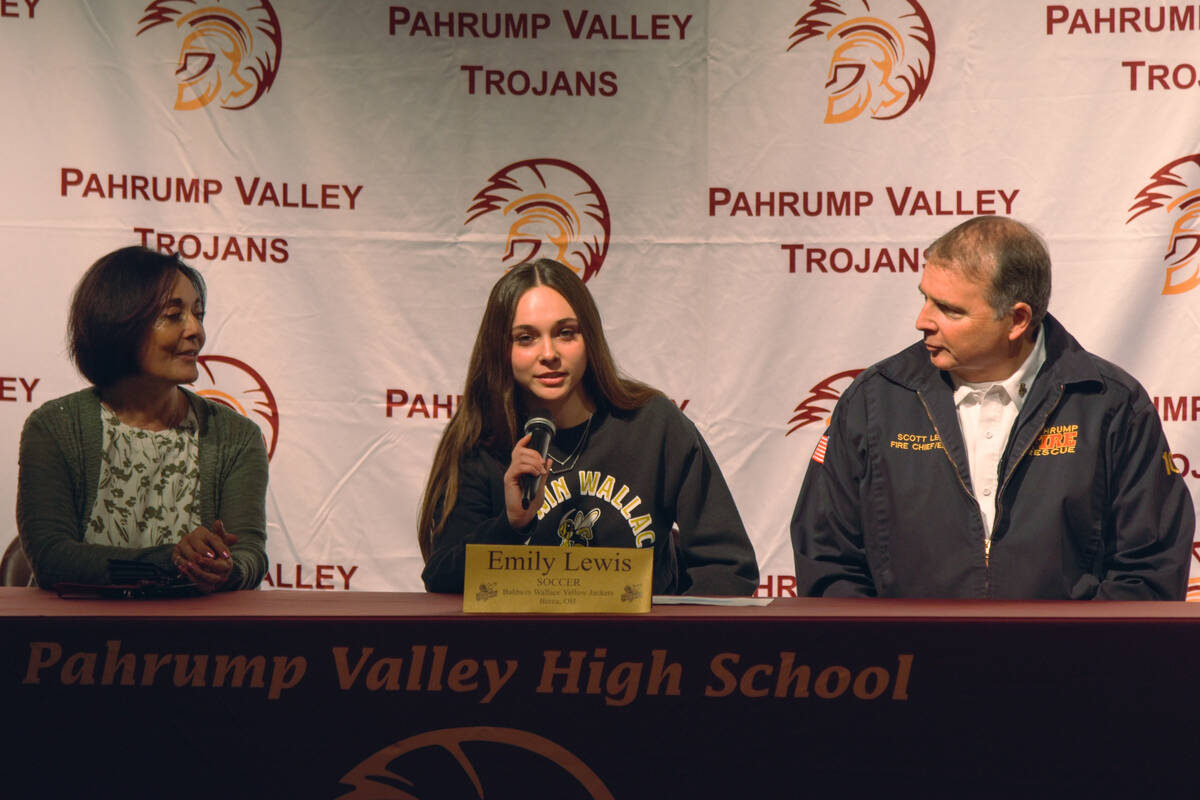 Emily Lewis (center) talking to the crowd before she signs her acceptance contract tract with w ...