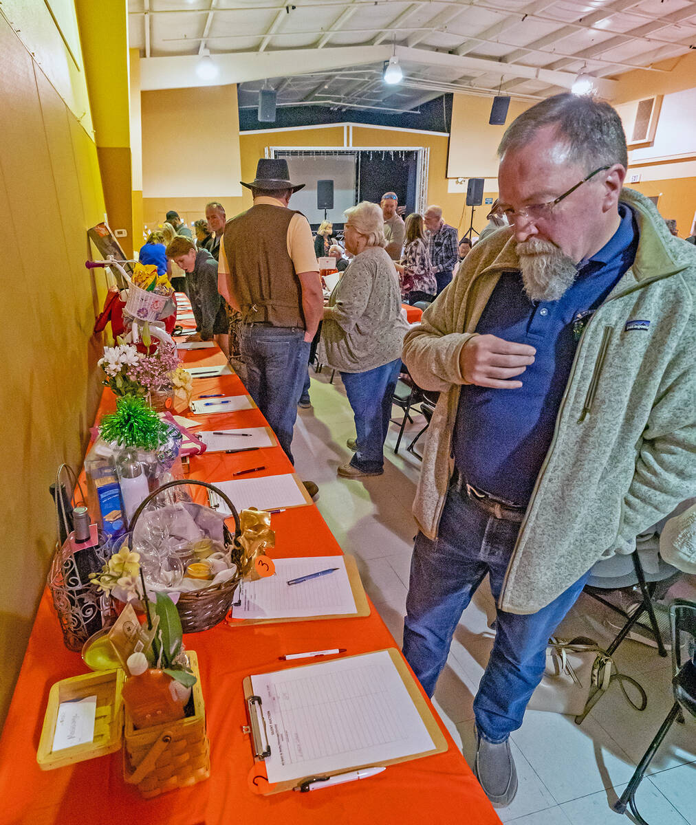John Clausen/Pahrump Valley Times Silent auction items lined a table on the back wall at the an ...